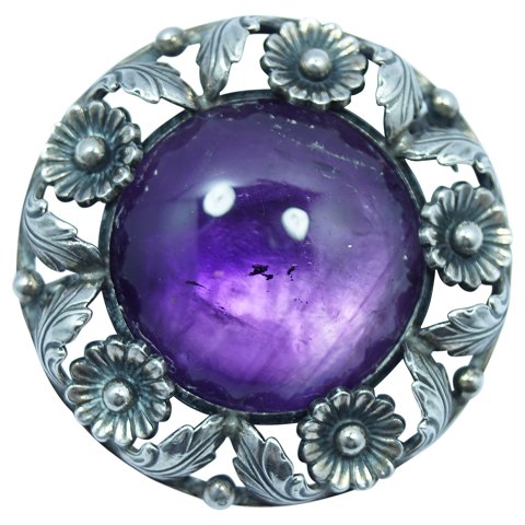 N. E. From; A brooch of sterling silver set with an amethyst