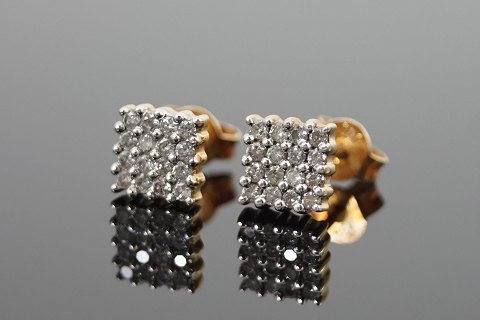 Ear rings set with diamonds mounted in 14k gold and white gold