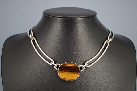 Niels Erik From; A necklace of sterling silver set with tiger-eye