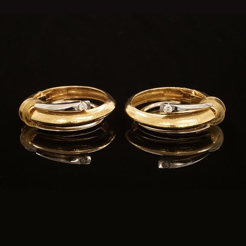 A pair of 14kt gold Ole Lynggaard, Copenhagen, 
earclips with a diamond. D: 31mm
