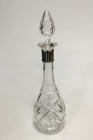 Carafe in facet cut glass with silver collar.