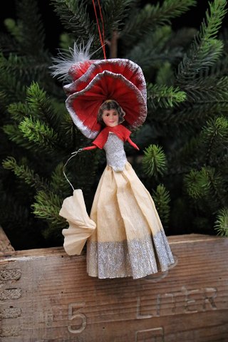 Old Christmas tree decoration, elegant lady with umbrella made of paper and 
glossy image...