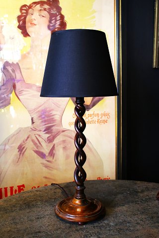 Old English table lamp in dark carved, twisted wood with black fabric 
lampshade...