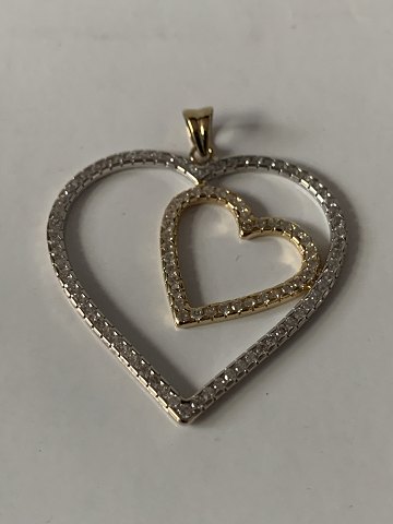 Heart-shaped pendant in 14 carat white and red gold clear stones.