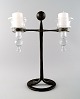 Erik Höglund/Hoglund for Kosta Boda. Sweden 60 / 70s.
Two armed candlestick made of cast iron with loose hand-blown art glass for 
candles.