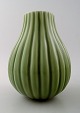 Axel Salto: A Royal Copenhagen stoneware vase modelled with vertical grooves in 
relief, decorated with celadon glaze.