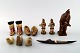A selection of Greenlandic artefacts, comprising, three wooden figures, a wood 
and bone kayak model, two pairs of doll