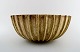 Arne Bang. Stoneware bowl with fluted corpus decorated with brown / ocher 
speckled glaze.