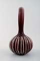 Axel Salto for Royal Copenhagen stoneware vase modelled with narrow mouth and 
vertical fluted pattern.