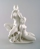 Harald Salomon for Rörstrand, white glazed porcelain Art Deco figure of a naked 
woman and flute-playing pan.