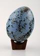 Scandinavian ceramist. Unique ceramic egg on stand, blue tones.

