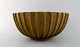 Arne Bang. Stoneware bowl with fluted corpus decorated with brown / ocher 
speckled glaze.