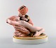 Royal Copenhagen. Gerhard Henning: "Eventyr III" figurgruppe af porcelæn, 
dekoreret i overglasurfarver og guld.