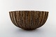 Arne Bang. Large stoneware bowl with fluted corpus decorated with brown speckled 
glaze.