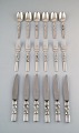 Georg Jensen. Cutlery, Scroll No. 22, Complete dinner service of hammered 
sterling silver.
