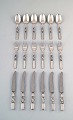 Georg Jensen. Cutlery, Scroll No. 22, full lunch service of hammered sterling 
silver.