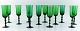 SIMON GATE ORREFORS, A set of 12 green champagne glasses in art glass.. 
