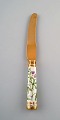 Georg Jensen for Royal Copenhagen. "Flora Danica" dinner knife of gold plated 
sterling silver. Porcelain handle decorated in colors and gold with flowers.