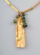 Björn Weckström for Lapponia. "Golden tree" necklace of 14 carat gold. Pendant 
hung with five round beads of agate. Dated 1972.