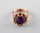 Jørgen Larsen, Danish goldsmith. 14 carat modernist gold ring adorned with 
purple stone.