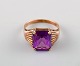 Edvard Berg, Danish goldsmith. 14 carat art deco gold ring adorned with purple 
stones.