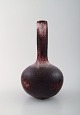 Axel Salto for Royal Copenhagen: Early vase in stoneware. Unusual oxblood glaze 
in many shades. Long necked shape. 1940
