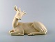 Armand Petersen for B&G (Bing & Grondahl). Rare art deco porcelain figure in the 
shape of lying deer. 1930