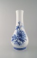 Oluf Jensen for Royal Copenhagen. Large unique porcelain vase with slim neck. 
Hand-painted with flowers. 1921.