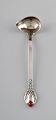 Evald Nielsen number 3, butter spoon / small sauce spoon in hammered all silver 
(830) with cabochon coral bead. 1920