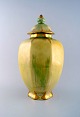 Josef Ekberg for Gustavsberg. Large art deco bojan / lidded jar in green and 
yellow glaze with gold decoration.