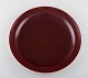 Confetti Royal Copenhagen / Aluminia faience. Dinner/ cover plate in burgundy 
red. 1940