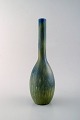 Carl-Harry Stålhane for Rørstrand. Large ceramic vase with narrow neck. 
Beautiful glaze in blue / green shades. 1960