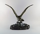 Peder Marius Jensen (1883-1925), Danish sculptor. Large and impressive eagle in 
patinated metal on black marble stand. 1910