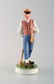 Royal Copenhagen porcelain figurine in high quality over glaze. Farmer / 
Guardian boy with lumber hammer. Model Number: 620.