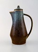 Carl Harry Stålhane for Rörstrand. Jug with lid in glazed stoneware.
Beautiful glaze in blue and brown shades. 1950/60