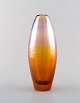 Lena Bergström for Orrefors. Vase in metallic amber colored mouth blown art 
glass. Dated 1996.