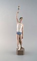 Lladro, Spain. Large rare figure in glazed porcelain. Athlete with the olympic 
torch. Dated 1984-88.
