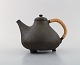 Hegnetslund Lervarefabrik, Denmark. Rare teapot in stoneware with inside 
turquoise glaze and wicker handle. 1960