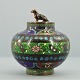 A cloisonne lid jar set with a dachshund in Viennese bronze