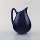Hertha Bengtson for Rörstrand. "Blå eld" jug in porcelain. Beautiful deep blue 
glaze. 1960