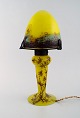 Charles Vessière, Nancy. Table lamp in yellow and blue/brown mouth blown art 
glass with leaf-shaped screen holder. Floral motif on the base. 1920 / 30