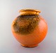 Svend Hammershøi for Kähler, Denmark. Large round vase in glazed stoneware. 
Beautiful orange uranium glaze. 1930/40