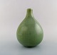 Axel Salto for Royal Copenhagen. Onion shaped stoneware vase, with horisontal 
grooves decorated with celadon glaze. 1940