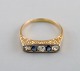 Scandinavian jeweler. 14 carat art deco gold ring adorned with brilliants and 
sapphires. Mid 20th century.
