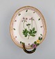 Royal Copenhagen Flora Danica leafshaped dish with handle and repousse flowers 
in hand painted porcelain. Dated 1928.
