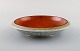 Royal Copenhagen. Bowl in crackled porcelain with gold and orange decoration. 
1930
