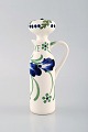 Aluminia (Denamark) lidded vinegar jug in hand-painted porcelain. Blue flowers 
and green leaves. Early 20th century.
