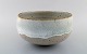 Alev Ebüzziya Siesbye for Royal Copenhagen. Stoneware circular bowl decorated 
with transparent gray and white glaze. 1960