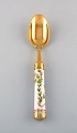 Michelsen for Royal Copenhagen. "Flora Danica" dinner spoon made of gold plated 
sterling silver. Porcelain handle decorated in colors and gold with flowers.
