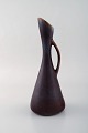 Gunnar Nylund for Rörstrand. Jug in glazed stoneware. Beautiful glaze in blue 
and brown shades. 1960